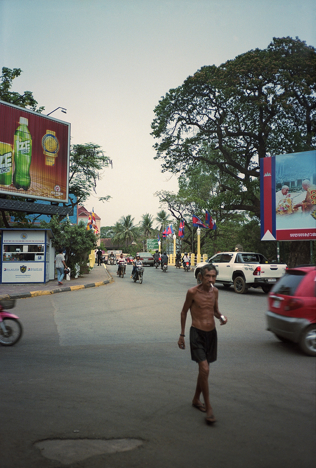 Topless man crossing the street in Siem Reap.
