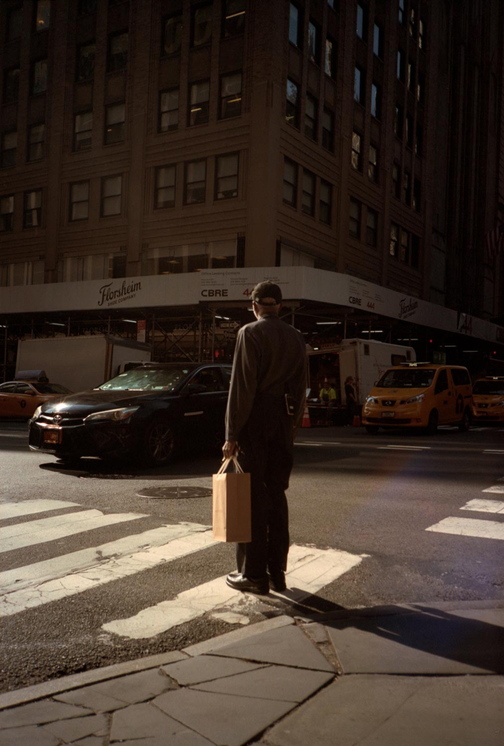 Man waiting at a crosswalk, Manhattan street scenes