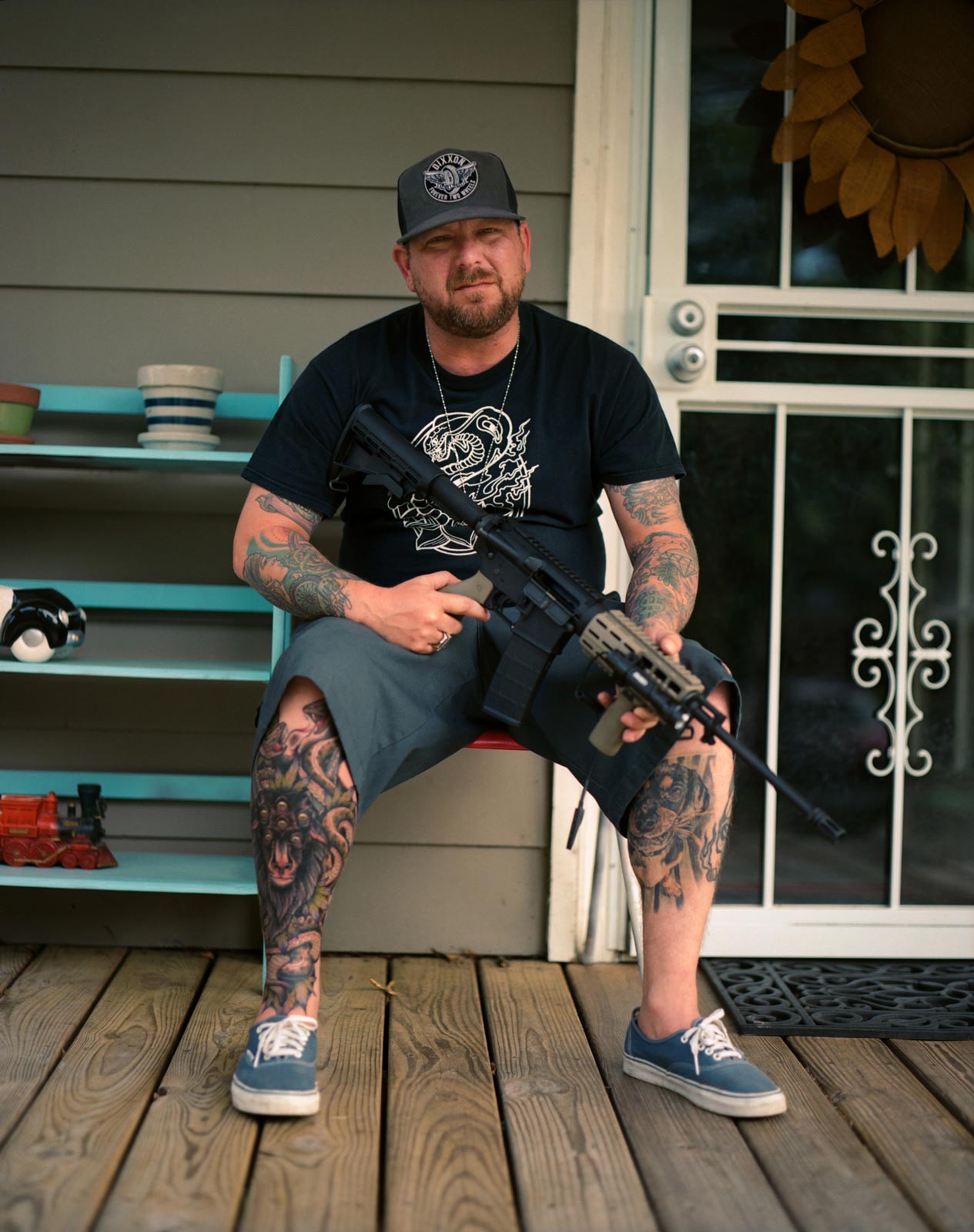 Derek showing his AK47 on his front porch in Memphis.