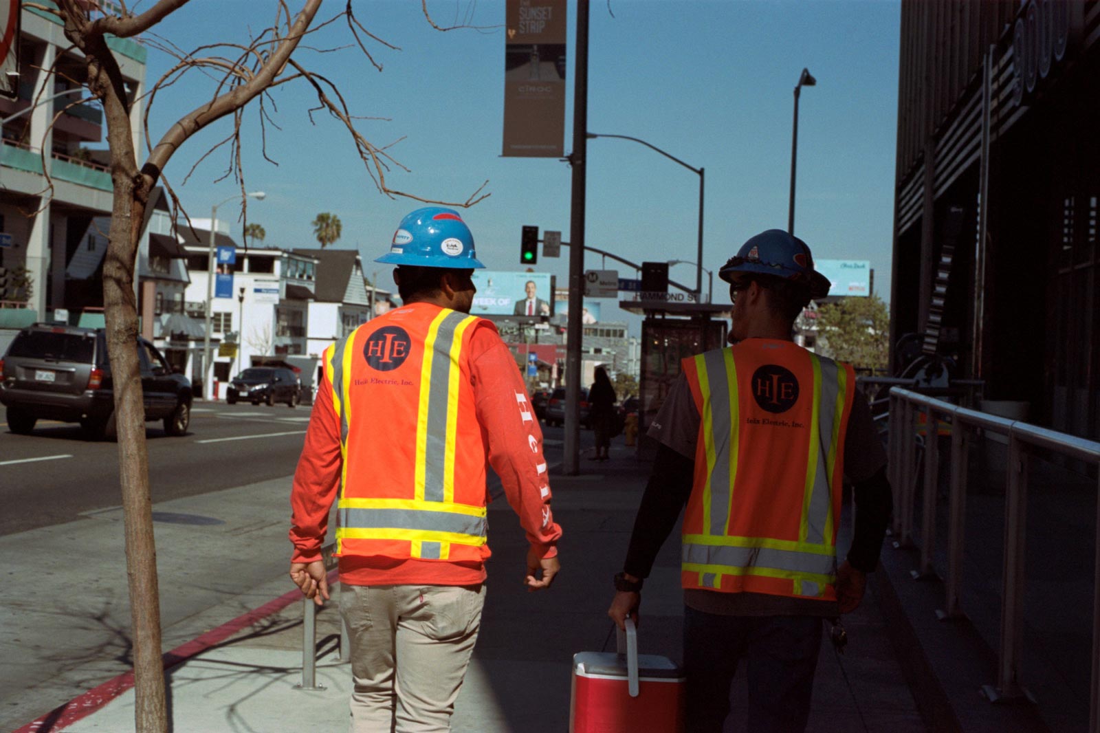 construction workers walking down sunset boulevard, los angeles.