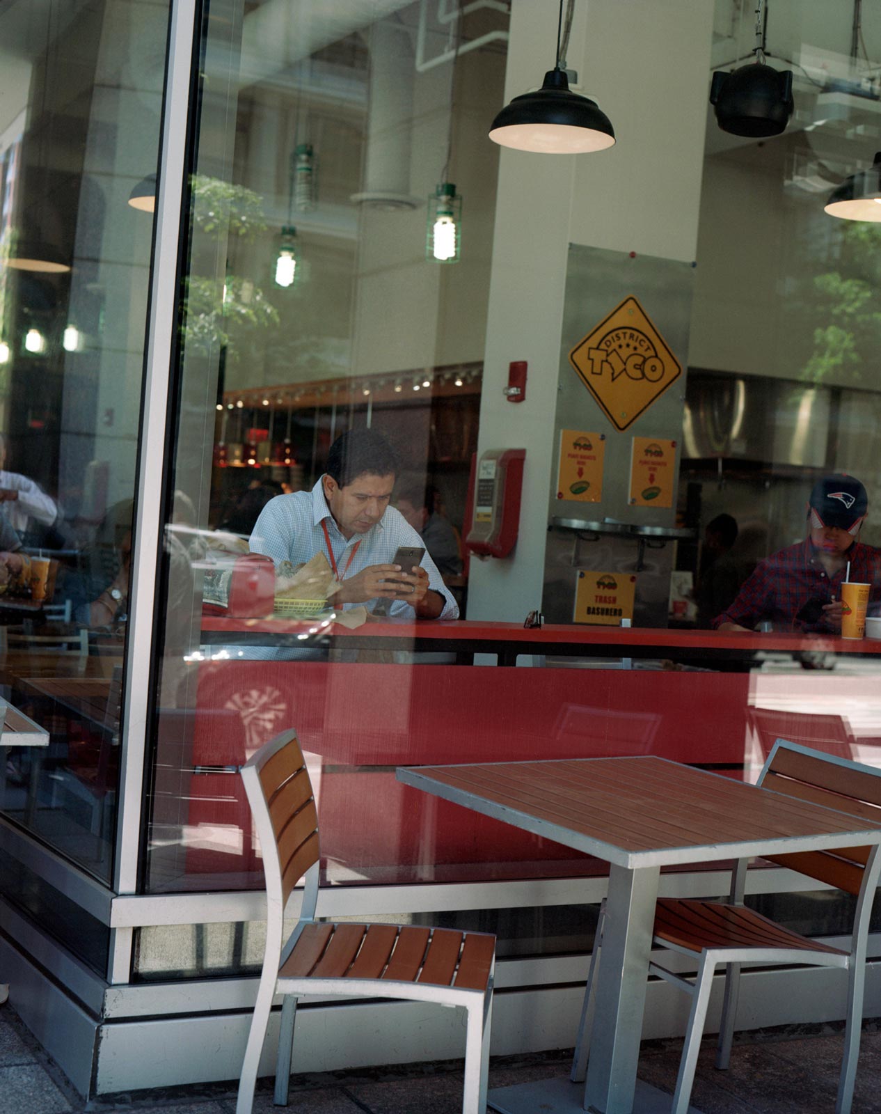 Man in a window eating lunch, Washington DC.