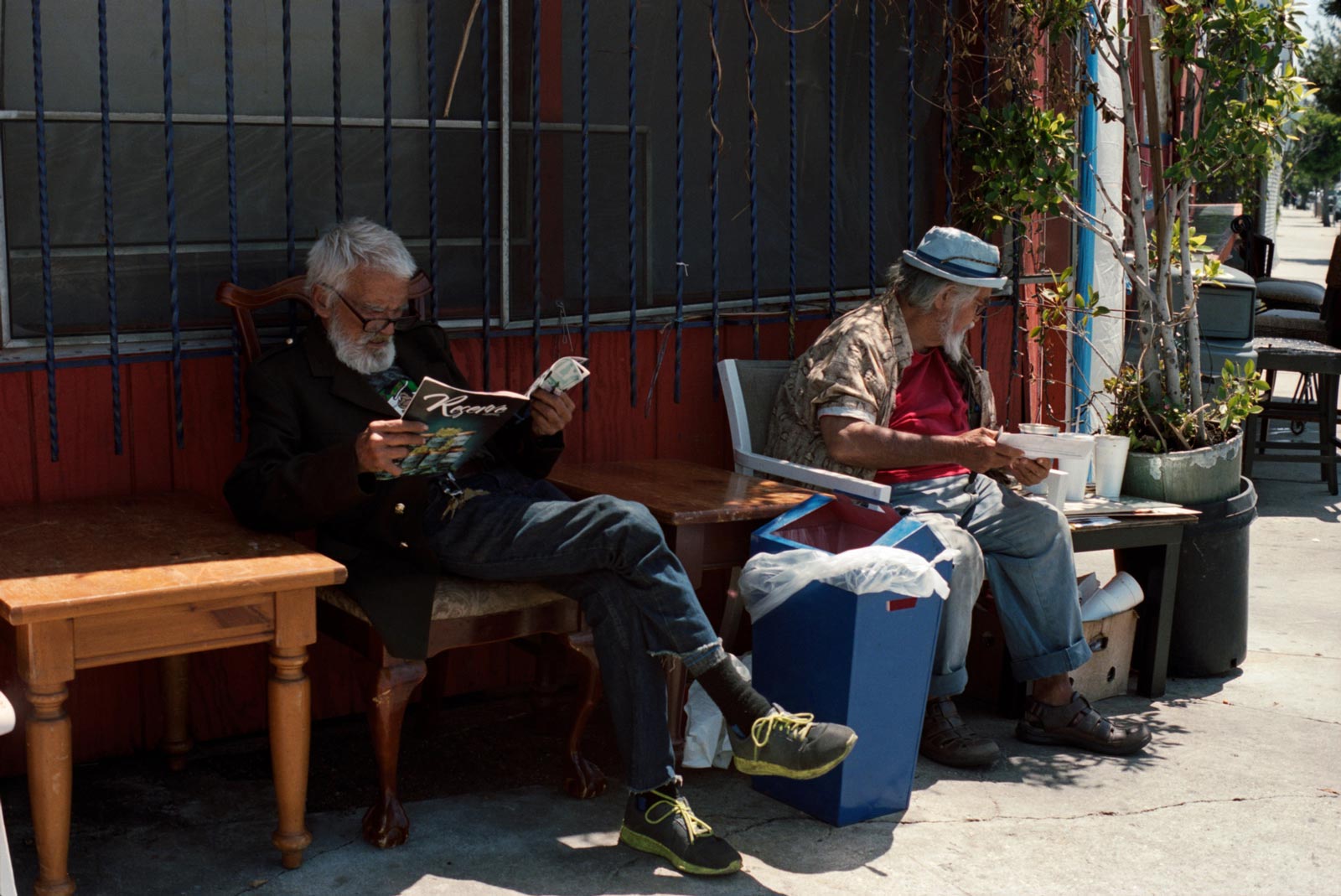 Men reading outside cafe downtown LA