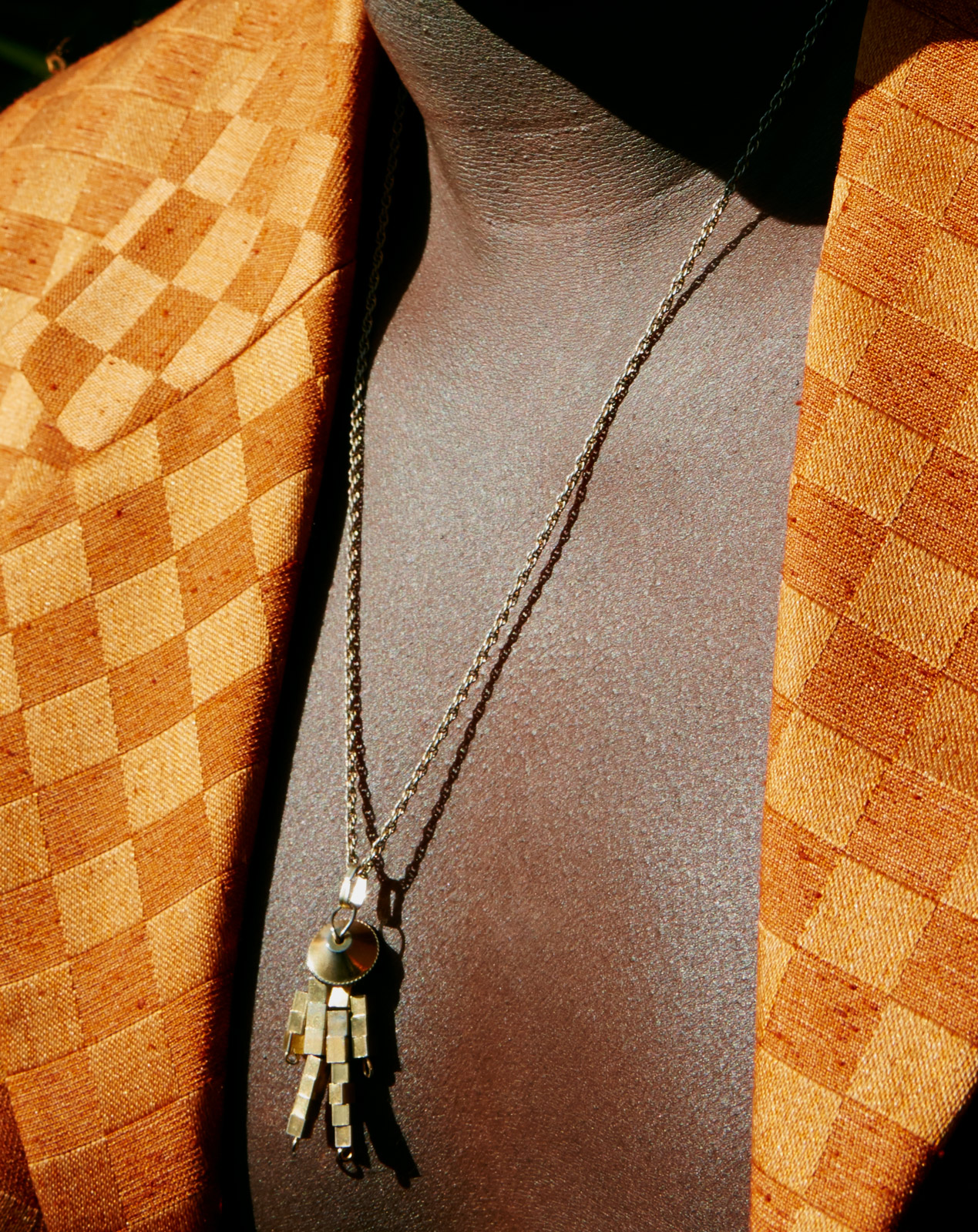 Biploar Sunshine, Musician close up detail of necklace.