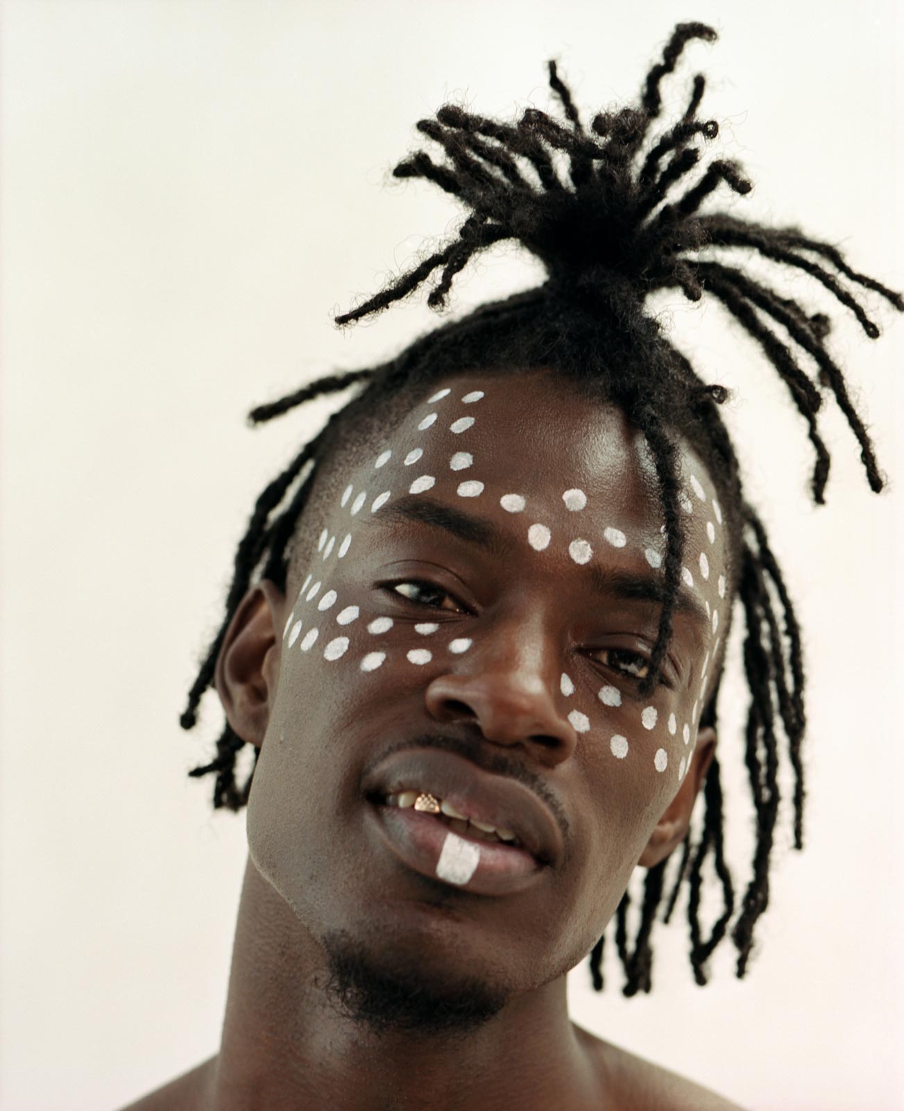 Mista Silva, close up portrait with high top hair twist, analogue photography.